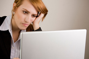 overwhelmed woman at computer