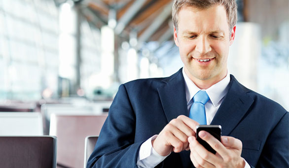 Entrepreneur Using a Mobile Phone at an Airport