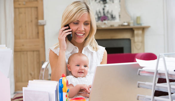 mom with a baby working from home office